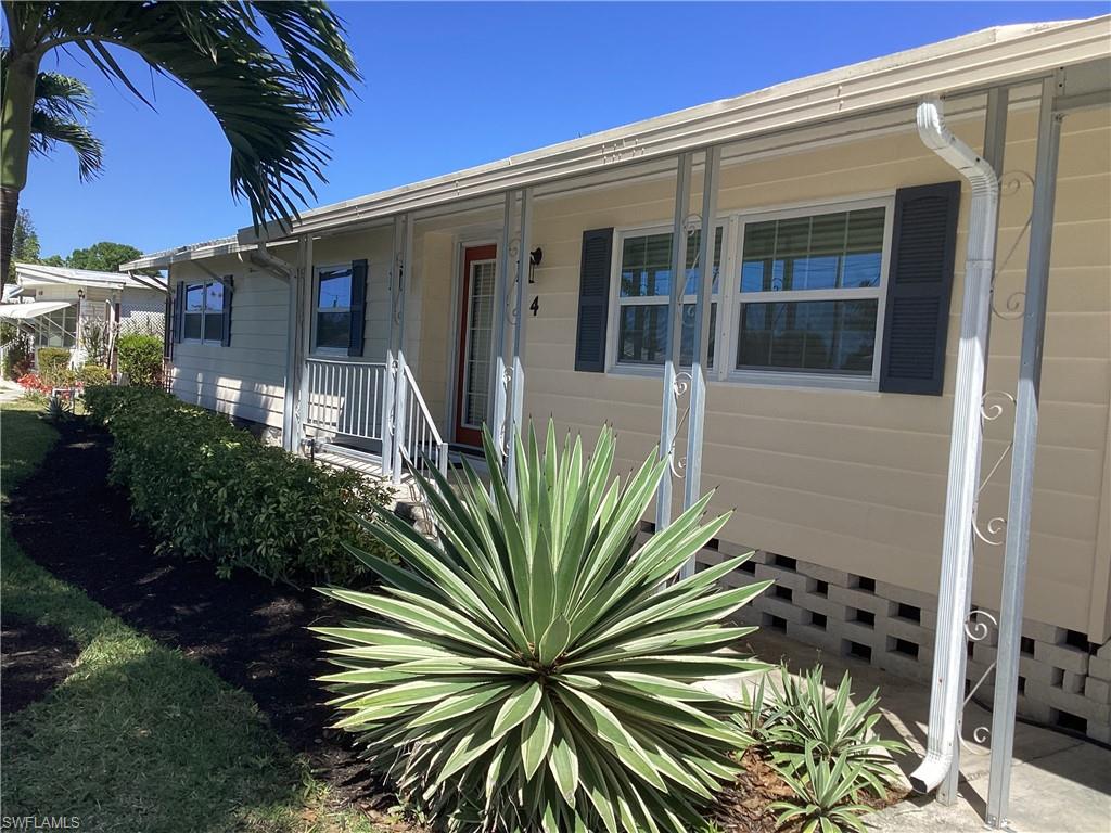 4 Chateau Way Naples, FL 34112 - Photo 4 of 45 a view of a house with a flower garden