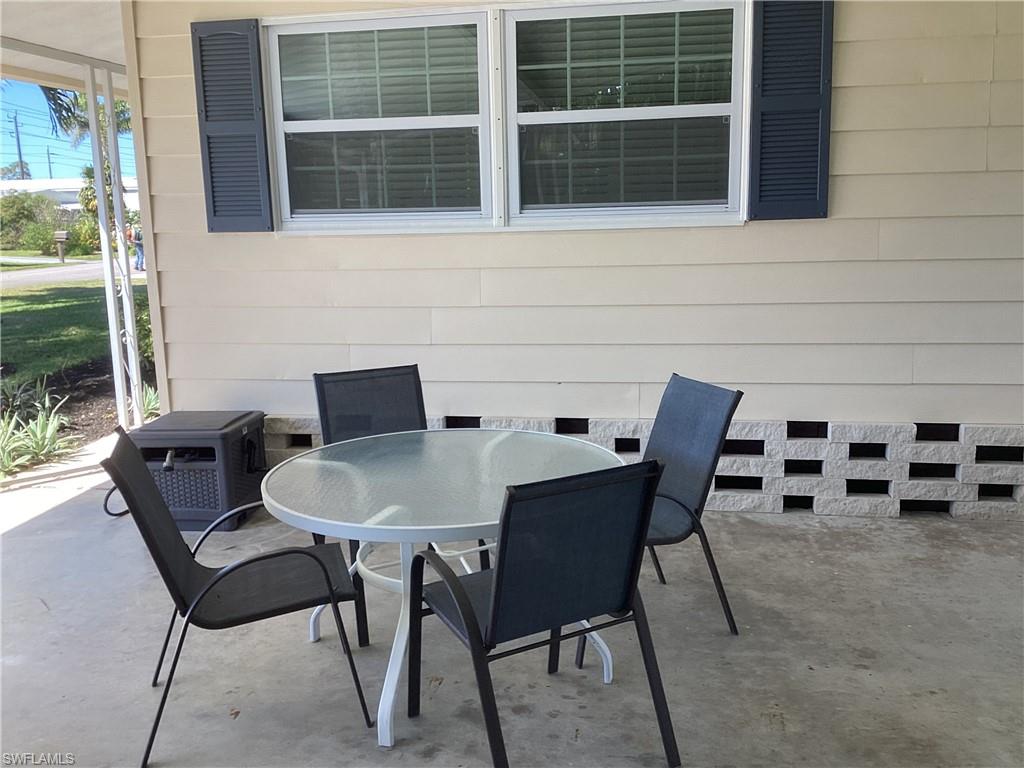 4 Chateau Way Naples, FL 34112 - Photo 6 of 45 a backyard of a house with table and chairs