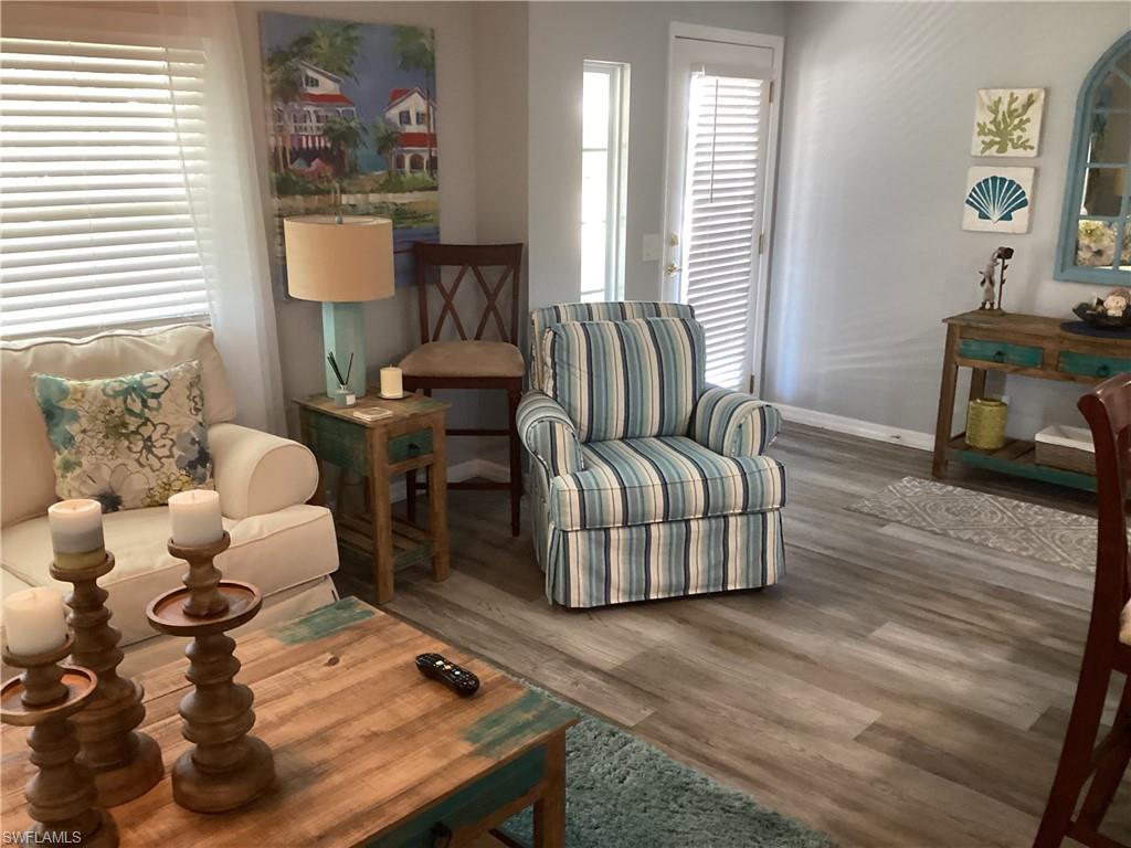 4 Chateau Way Naples, FL 34112 - Photo 9 of 45 a living room with furniture and wooden floor