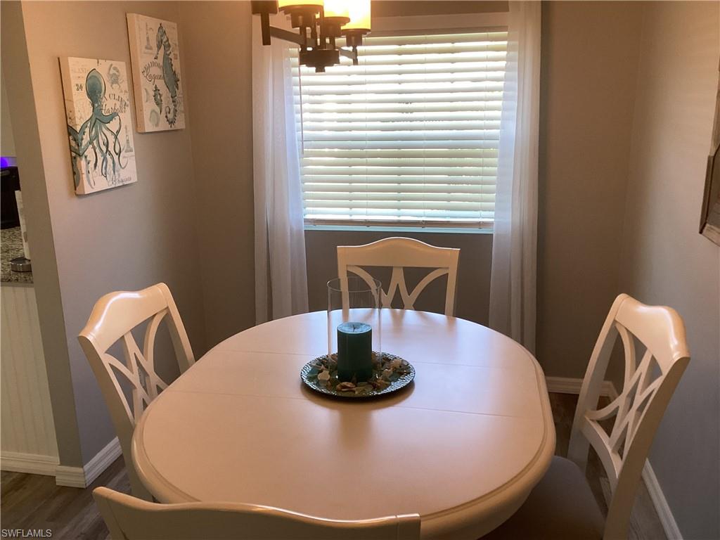 4 Chateau Way Naples, FL 34112 - Photo 10 of 45 a view of a dining room with furniture and wooden floor