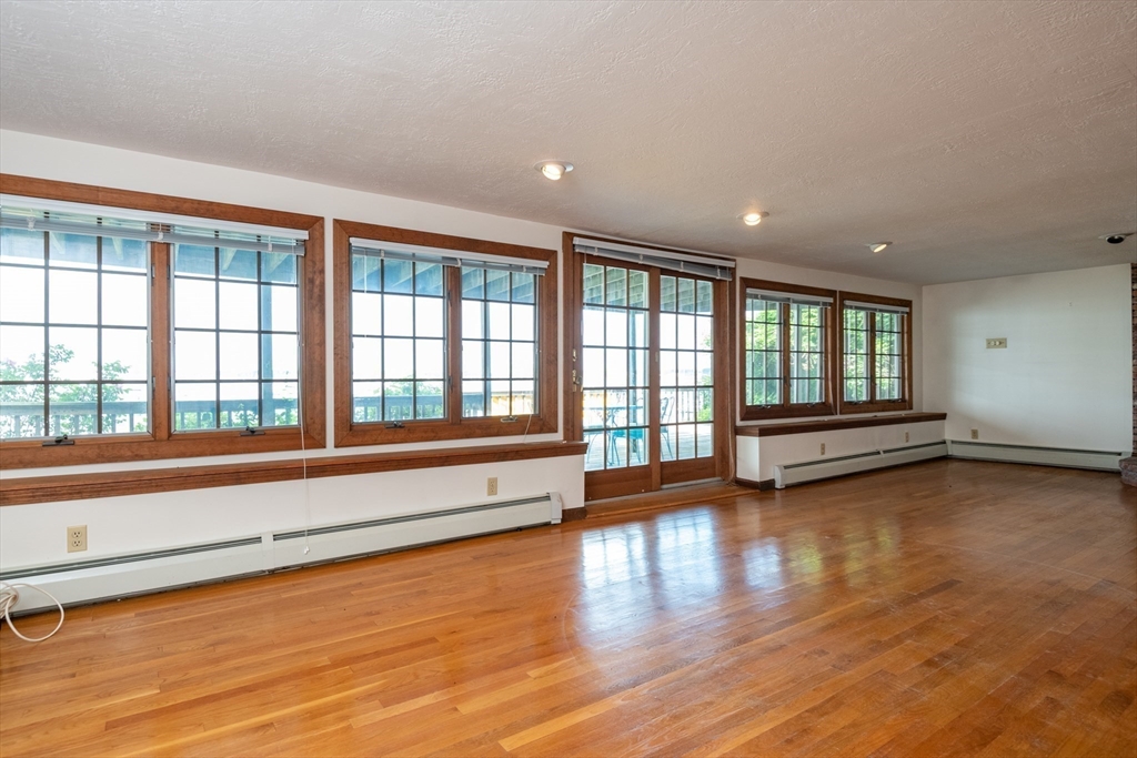 97 Pitman Road Marblehead, MA 01945 - Photo 15 of 37 a view of empty room with wooden floor and fan