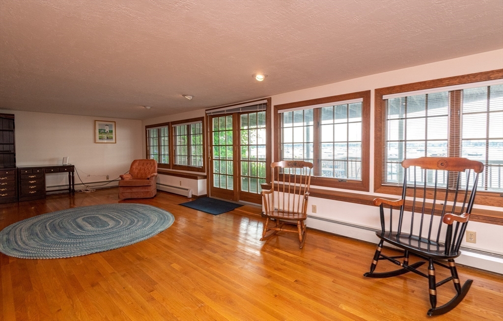 97 Pitman Road Marblehead, MA 01945 - Photo 31 of 37 a living room with furniture a rug and a large window