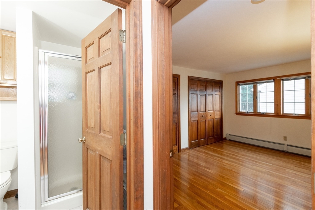 97 Pitman Road Marblehead, MA 01945 - Photo 34 of 37 a view of an empty room with wooden floor and a window