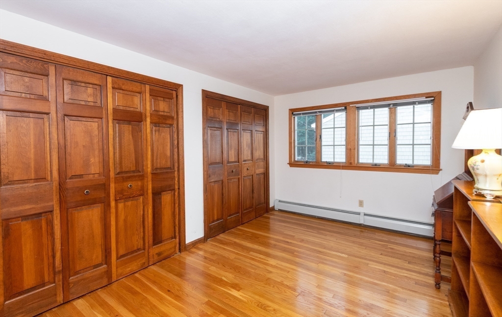 97 Pitman Road Marblehead, MA 01945 - Photo 36 of 37 an empty room with wooden floor and windows