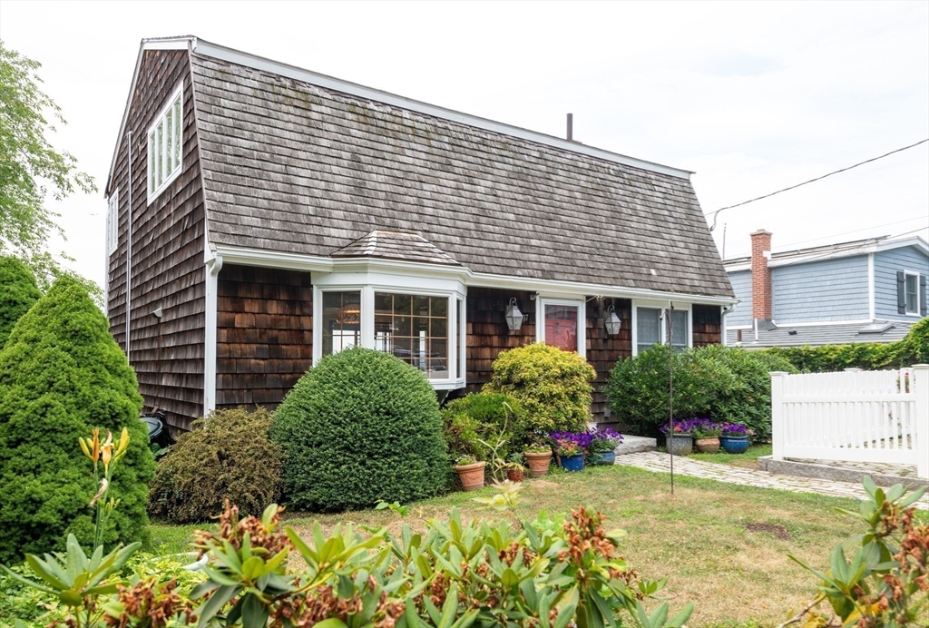 97 Pitman Road Marblehead, MA 01945 - Photo 8 of 37 a front view of a house with a yard and outdoor seating