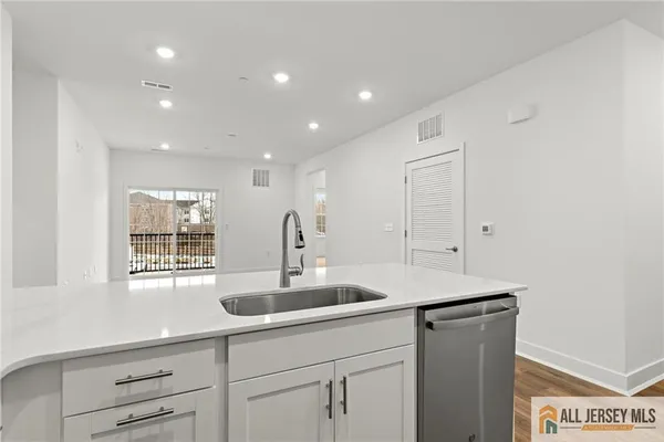 a kitchen with a sink cabinets and window