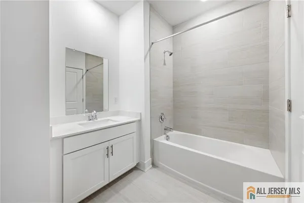 a bathroom with a granite countertop sink a toilet and shower