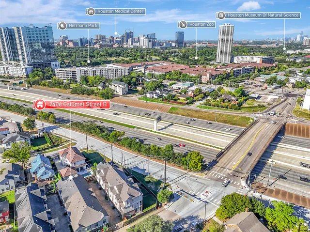 a spacious bedroom with a large bed and a chandelier