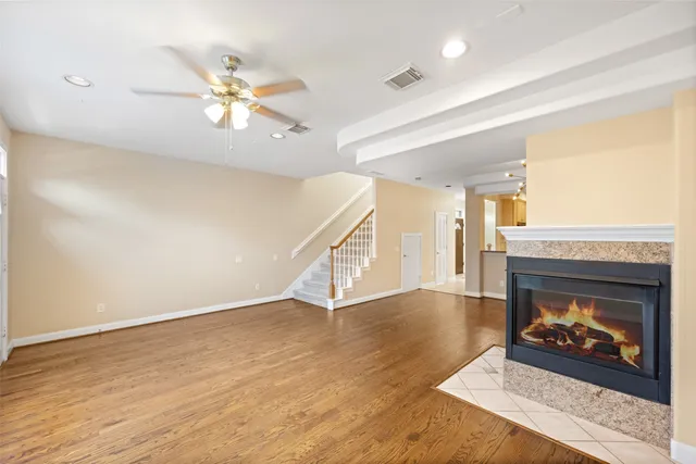 a view of a dining room with furniture a chandelier and wooden floor