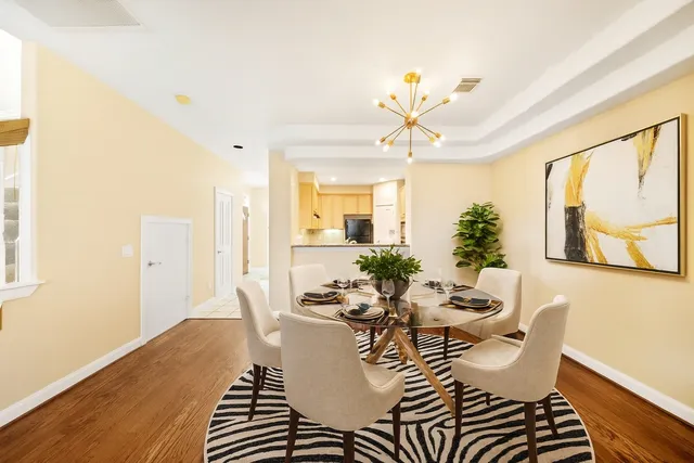 a view of a room with wooden floor and chandelier