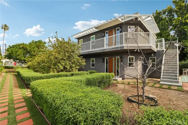 a front view of a house with garden