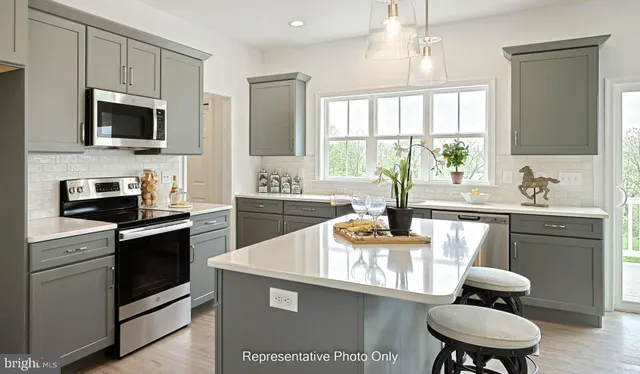a kitchen with a sink stove and microwave