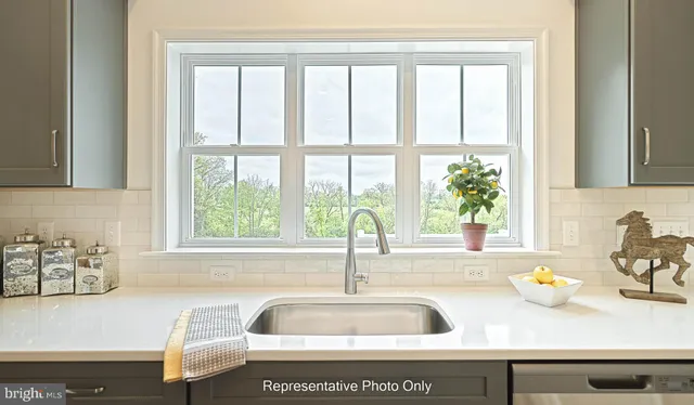 a kitchen with sink a window and a counter top space
