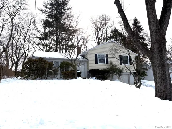 a view of a house with a yard covered in snow