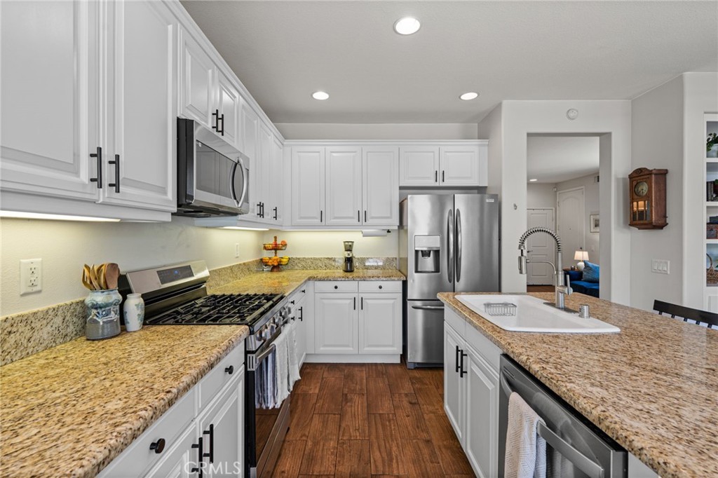 28356 Santa Rosa Lane Saugus, CA 91350 - Photo 8 of 50 a kitchen with stainless steel appliances granite countertop a sink stove refrigerator and cabinets