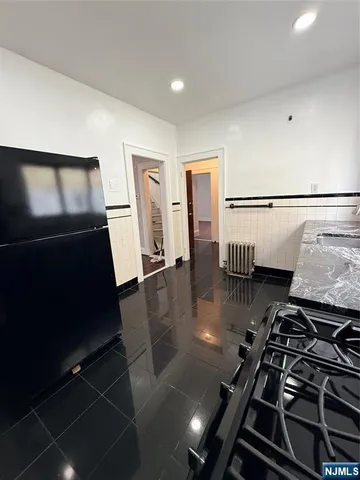 a kitchen with a stove and a refrigerator