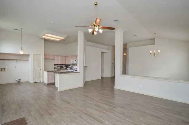 a kitchen with kitchen island white cabinets and refrigerator