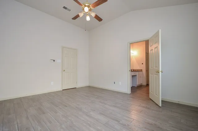 an empty room with wooden floor and closet
