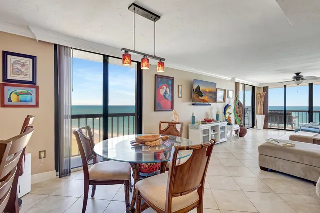 a dining room with furniture a chandelier and window