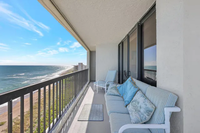 a balcony view with couches and wooden floor