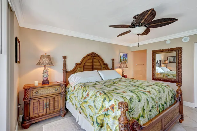 a bedroom with a bed and dresser with mirror