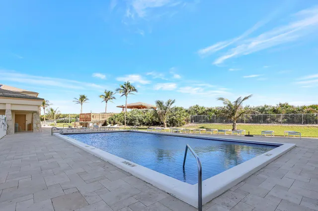 a view of a swimming pool with a lounge chairs