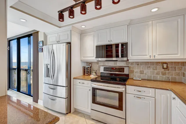 a kitchen with stainless steel appliances a refrigerator stove and microwave