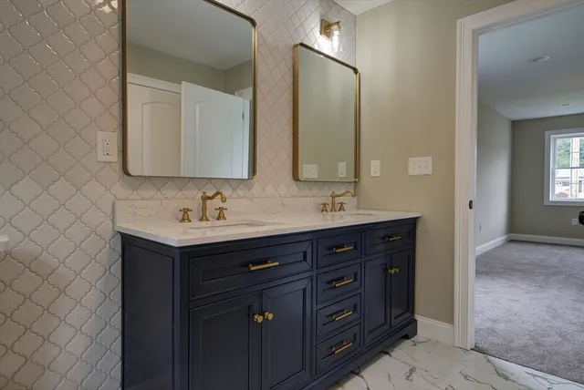 a bathroom with a double vanity sink mirror and