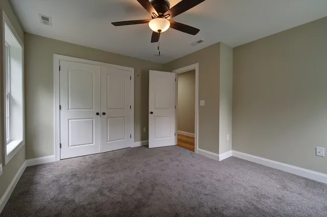 a view of empty room with ceiling fan