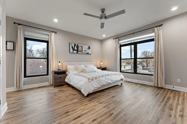 a bedroom with a large bed and a chandelier