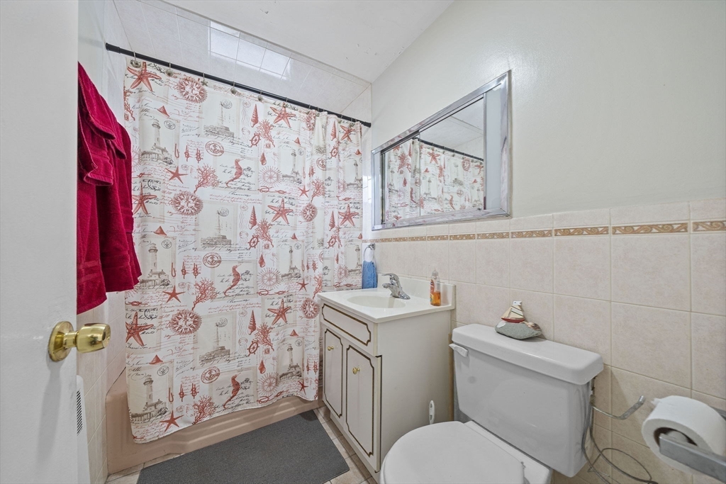 15 D Street Hull, MA 02045 - Photo 21 of 42 a bathroom with a toilet sink and mirror