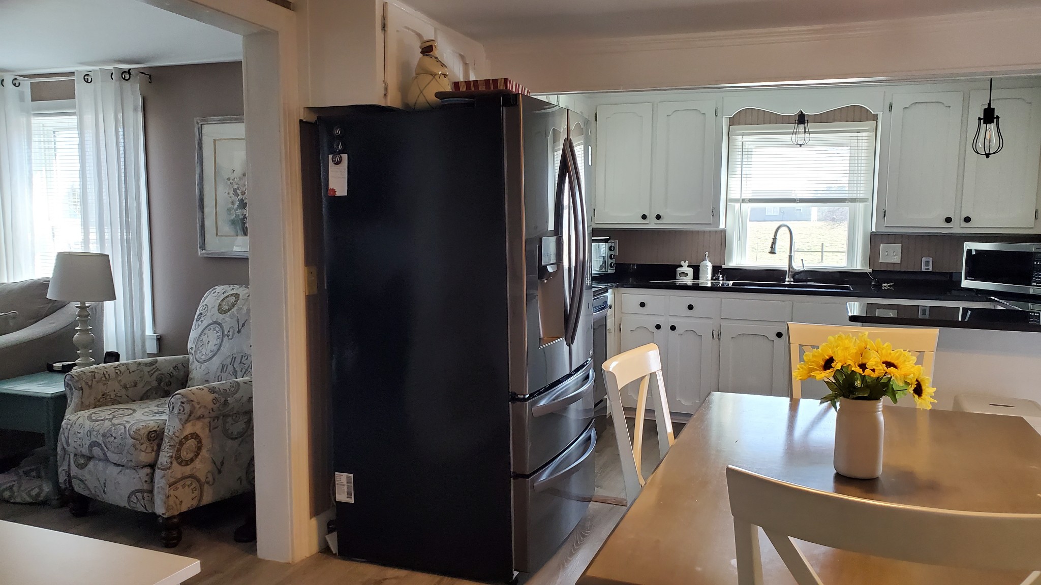 2073 Fall River Road Leoma, TN 38468 - Photo 5 of 44 a kitchen with stainless steel appliances granite countertop a refrigerator a stove and a sink with wooden floor