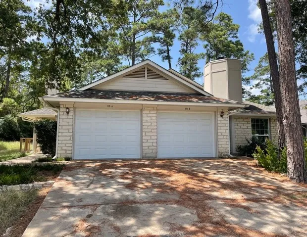 a front view of house with yard and trees