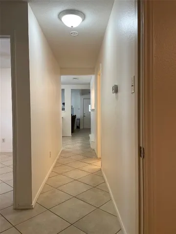 a view of a hallway with a furniture and a bathroom