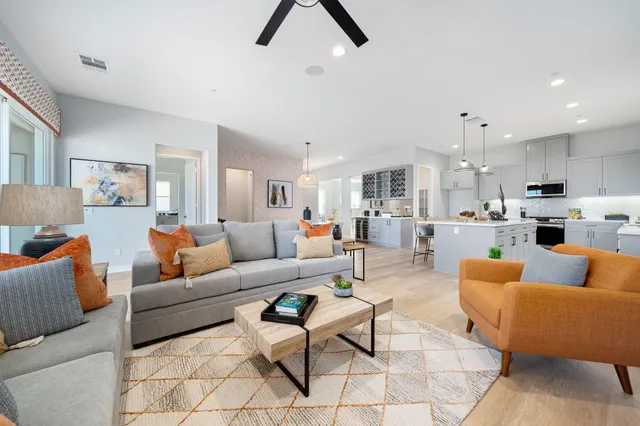 a living room with furniture and kitchen view