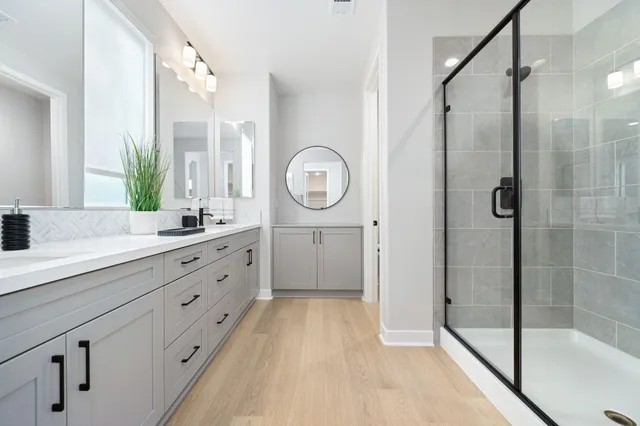 a spacious bathroom with a double vanity sink mirror toilet shower and bathtub