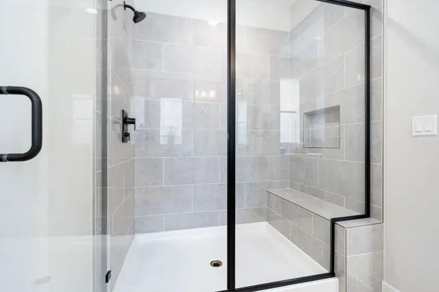 a bathroom with a glass shower door