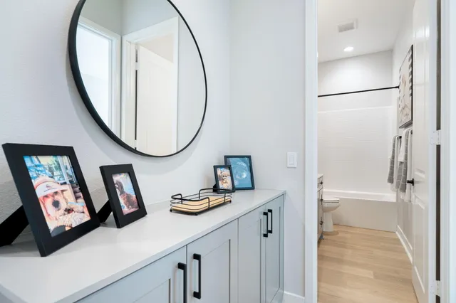 a bathroom with a granite countertop sink and a mirror