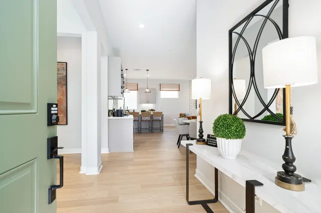 a living room with furniture a chandelier and a flat screen tv
