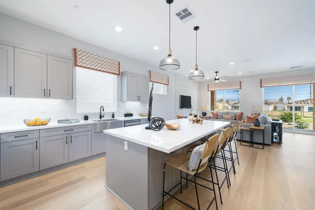a large kitchen with a table and chairs