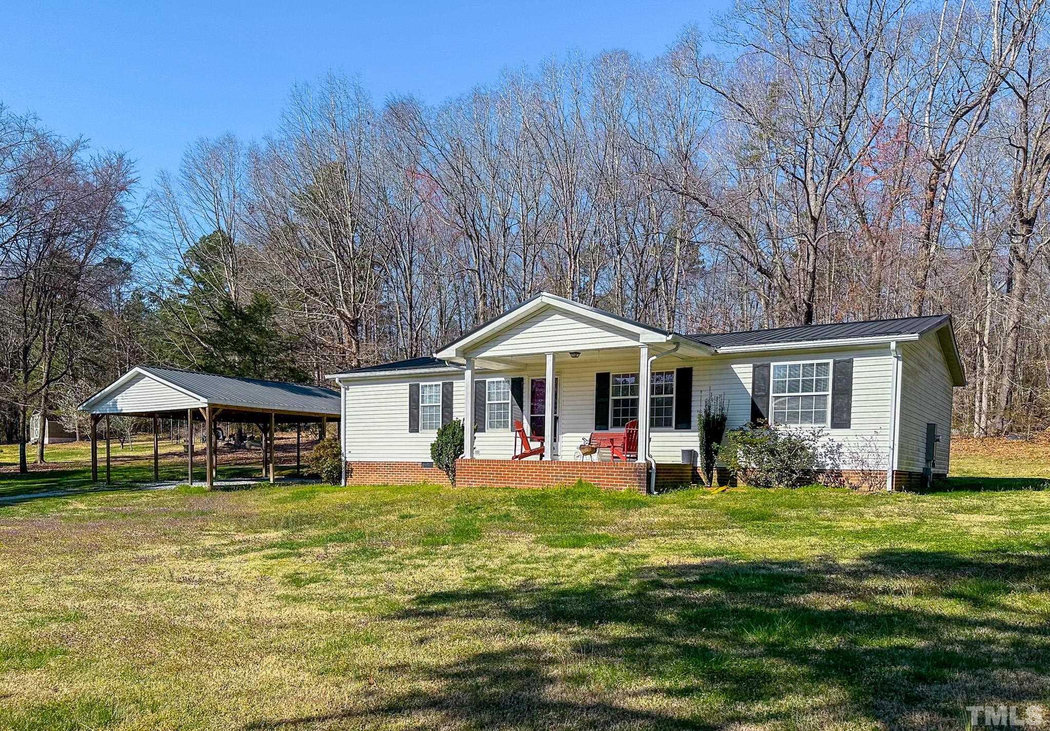 214 Hassel Clayton Road Roxboro, NC 27574 - Photo 1 of 38 a front view of a house with a yard
