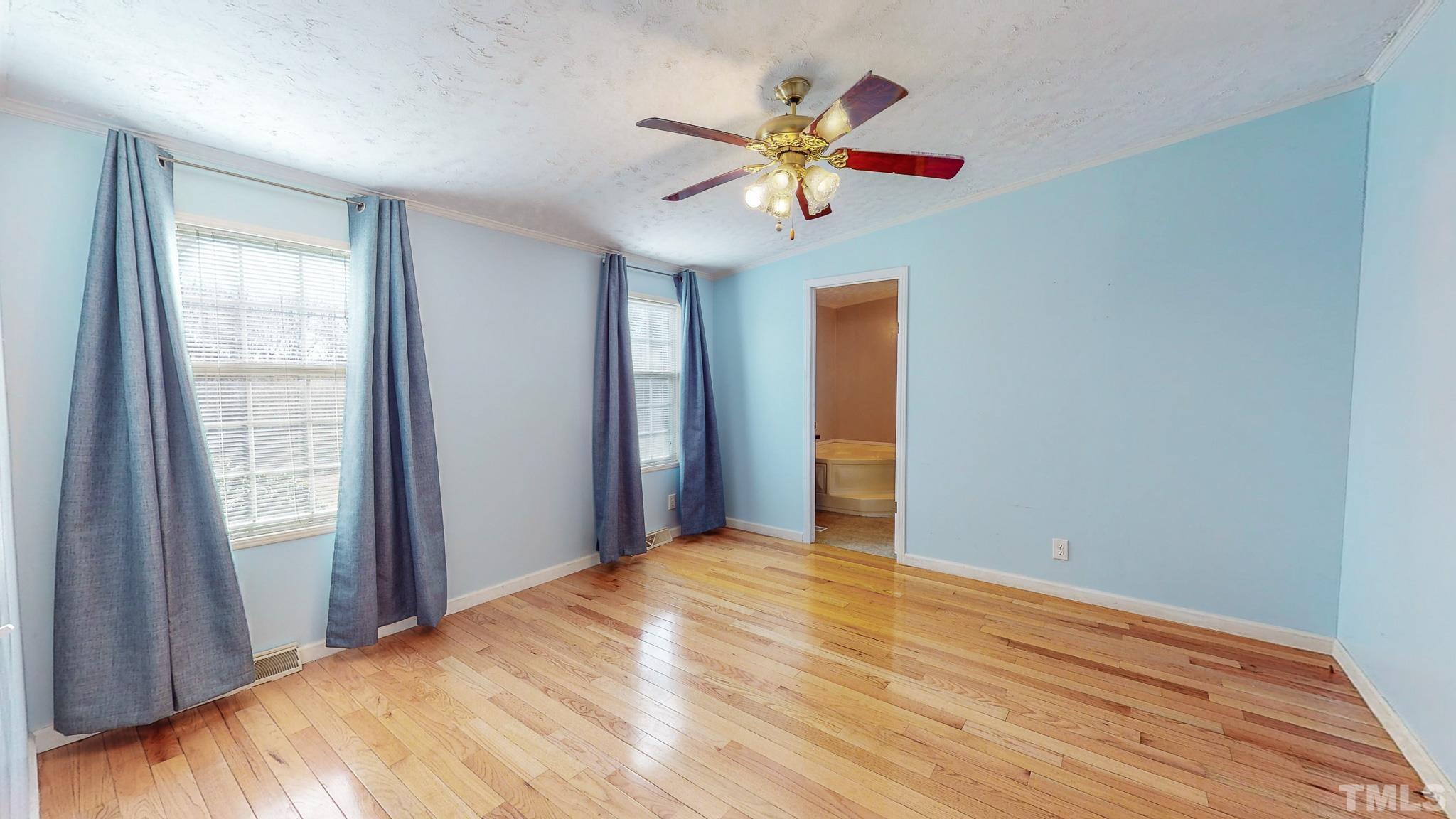 214 Hassel Clayton Road Roxboro, NC 27574 - Photo 13 of 38 a view of a bedroom with a ceiling fan and window