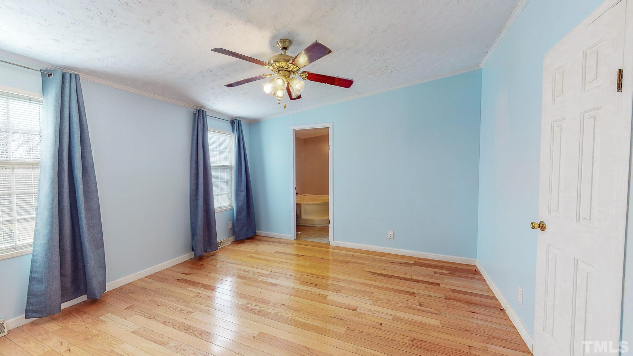 214 Hassel Clayton Road Roxboro, NC 27574 - Photo 14 of 38 a view of a hallway with a chandelier fan and wooden floor