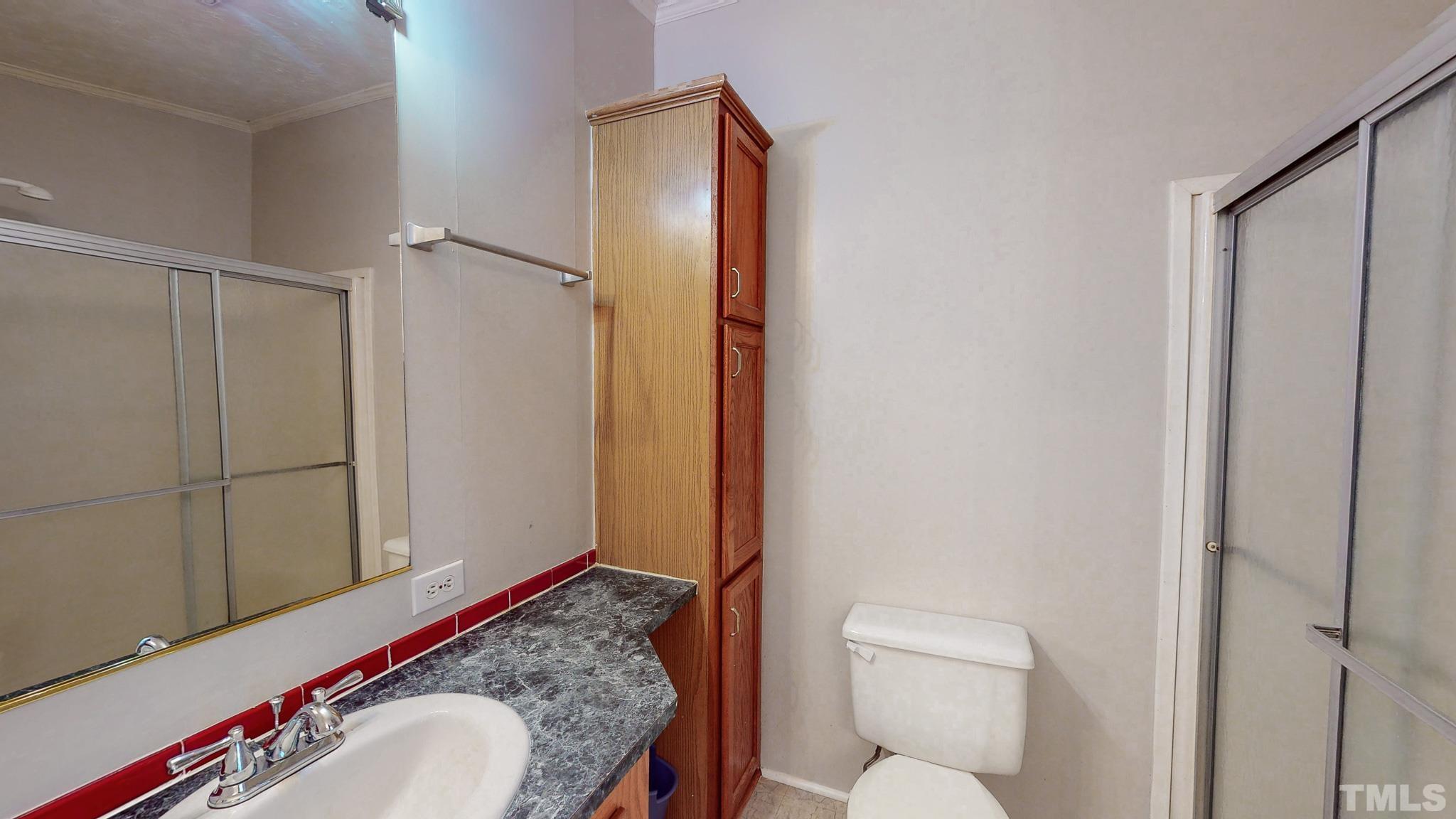 214 Hassel Clayton Road Roxboro, NC 27574 - Photo 17 of 38 a bathroom with a granite countertop toilet and a sink