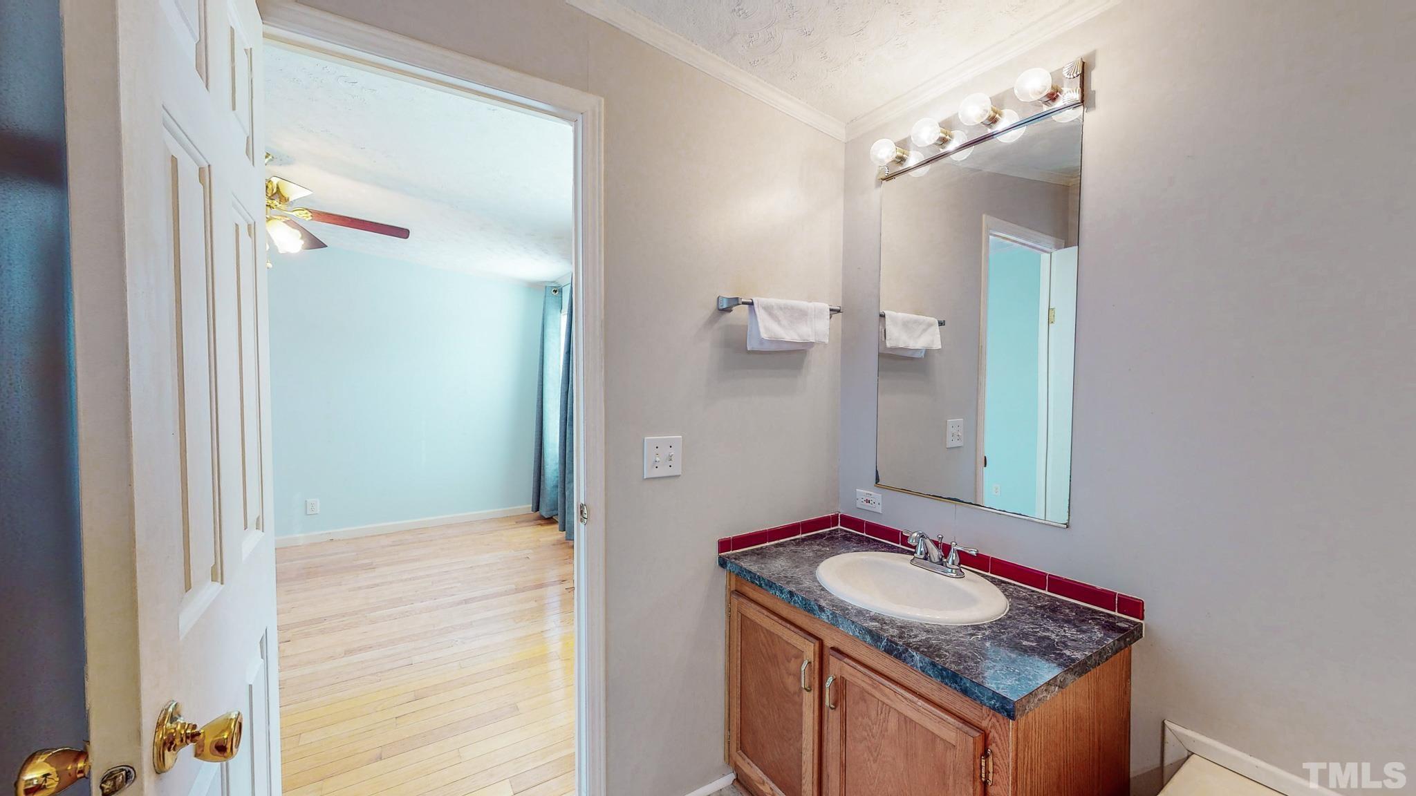 214 Hassel Clayton Road Roxboro, NC 27574 - Photo 18 of 38 a bathroom with a granite countertop sink and a mirror