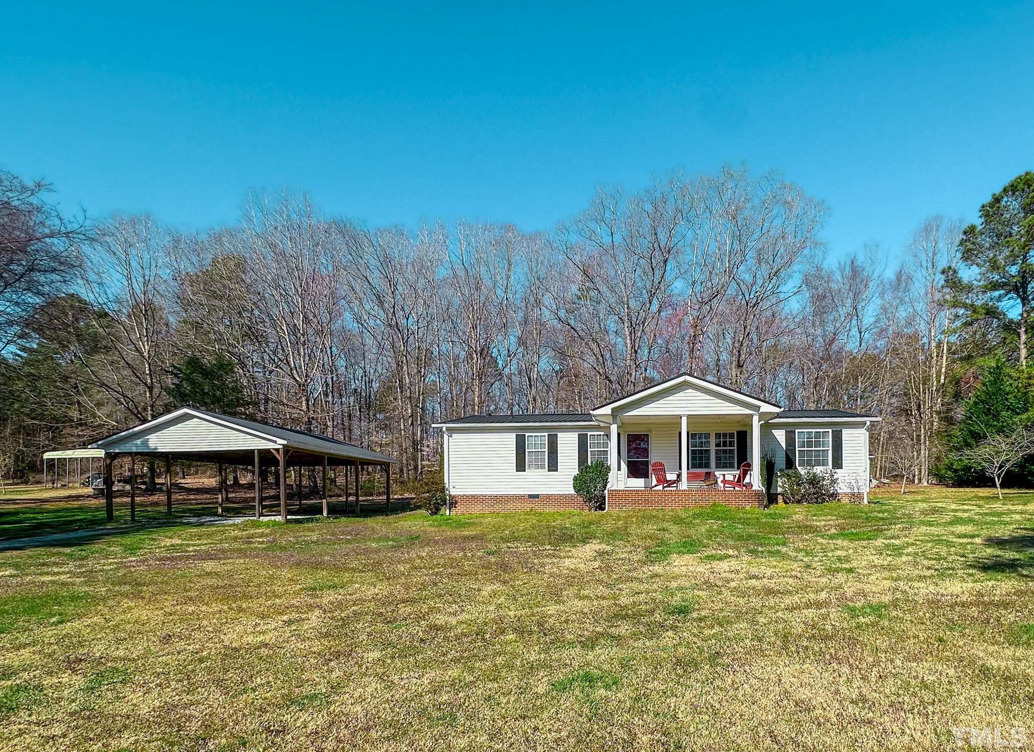 214 Hassel Clayton Road Roxboro, NC 27574 - Photo 19 of 38 a front view of a house with a yard