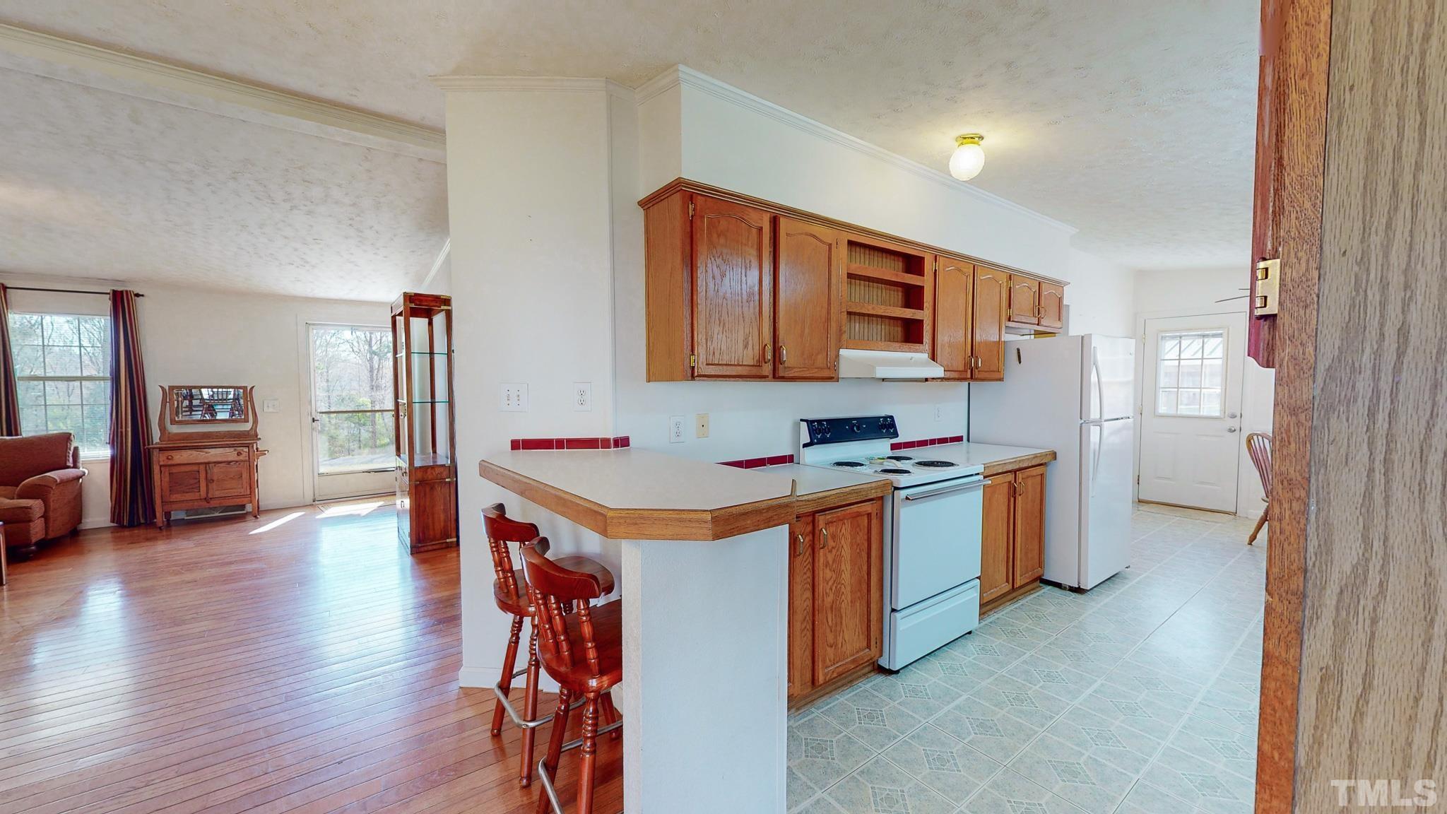 214 Hassel Clayton Road Roxboro, NC 27574 - Photo 20 of 38 a kitchen with stainless steel appliances granite countertop a stove and a refrigerator