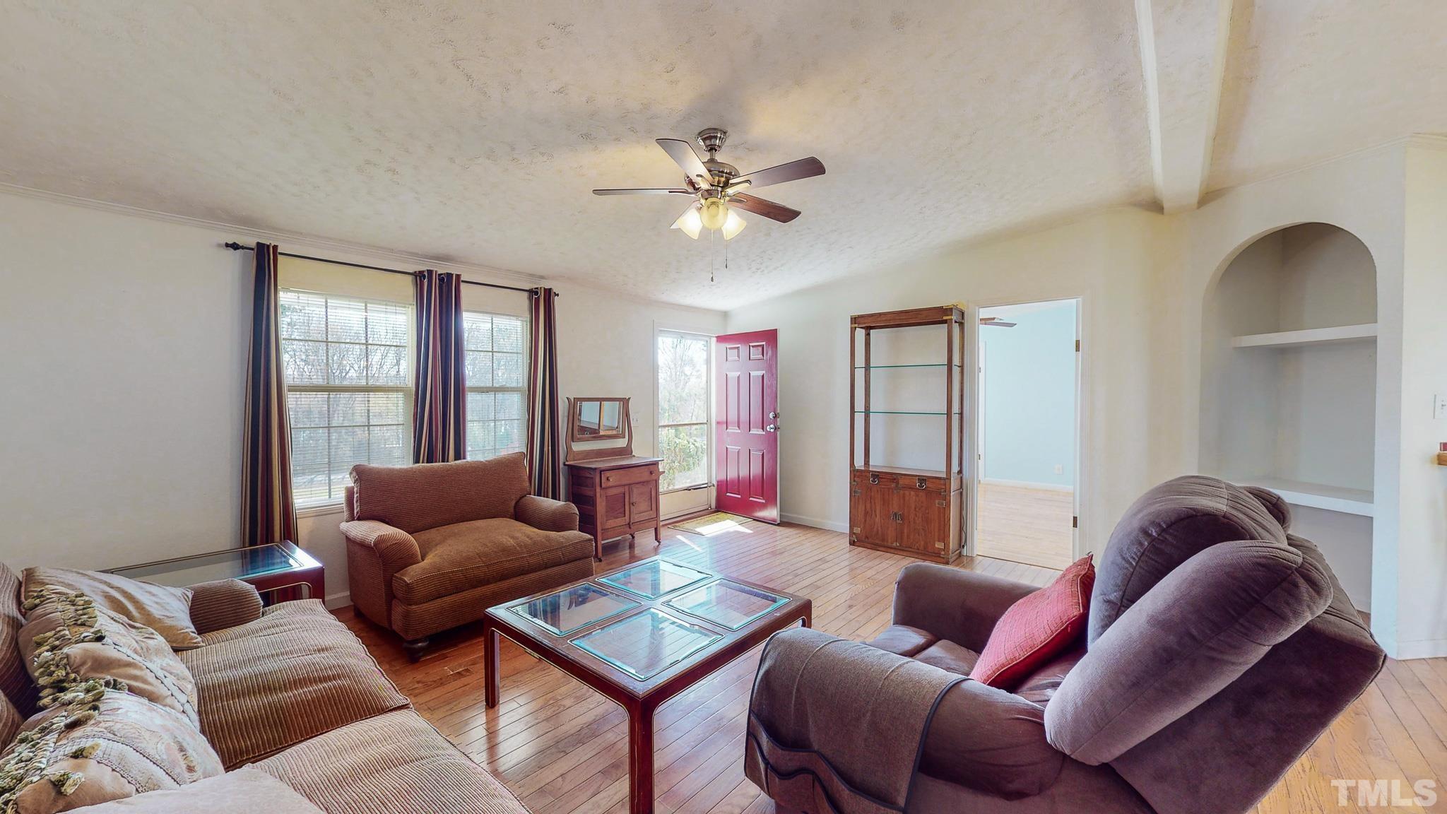 214 Hassel Clayton Road Roxboro, NC 27574 - Photo 2 of 38 a living room with furniture ceiling fan and a window
