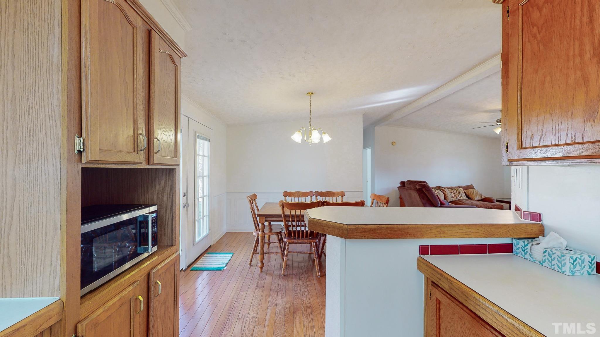 214 Hassel Clayton Road Roxboro, NC 27574 - Photo 22 of 38 a room with a table chairs and a kitchen view