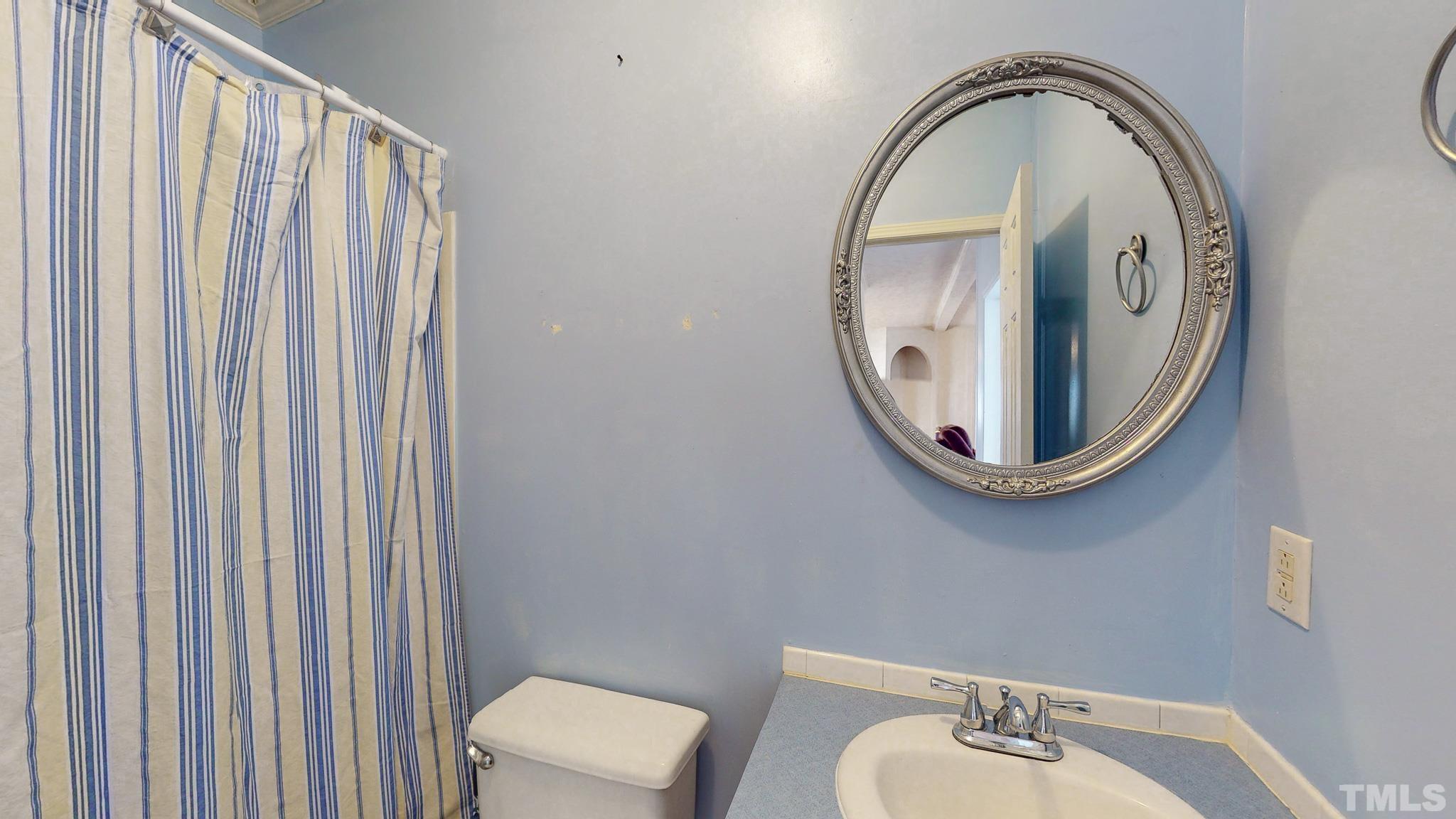 214 Hassel Clayton Road Roxboro, NC 27574 - Photo 33 of 38 a bathroom with a sink and a mirror